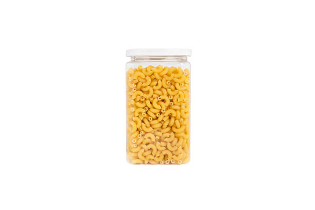 istock Pasta (macaroni) in plastic jar, isolated on white background with clipping path. 1289491873