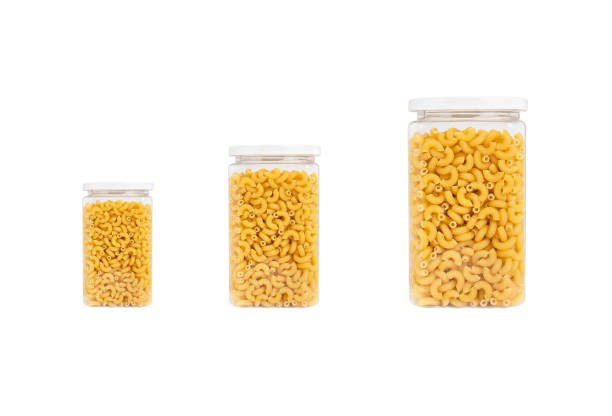 istock Pasta (macaroni) in plastic jar, isolated on white background 1289491874