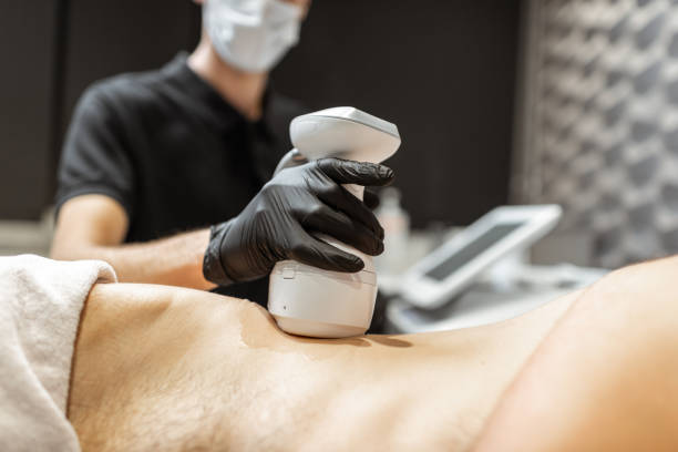 istock Ultrasound liposuction procedure for a male client 1289500054