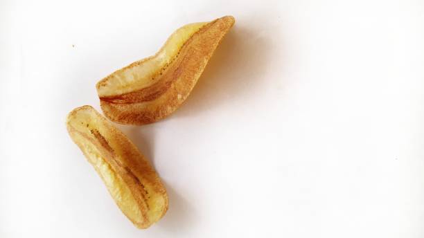 istock Fried sliced banana chips on white background. 1289501139