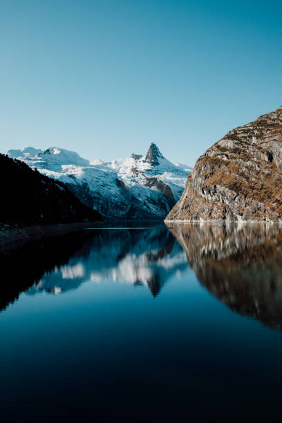istock Mountain Peak Reflected in Alpine Lake 1289502560