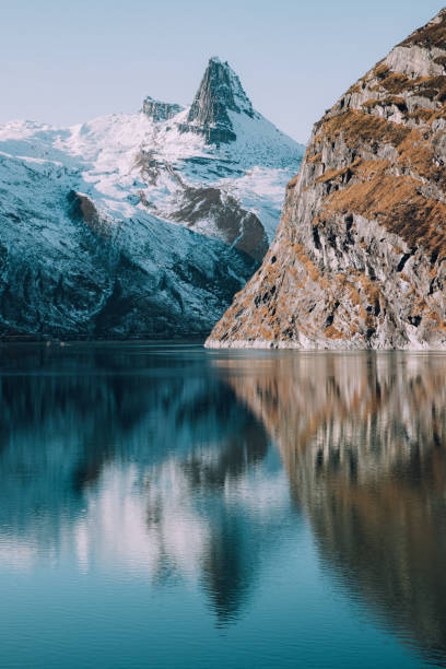 istock Mountain Peak Reflected in Alpine Lake 1289502567