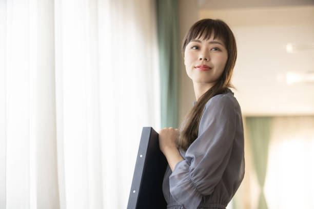 istock Woman holding a file 1289507336