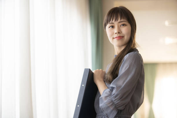 istock Woman holding a file 1289507353