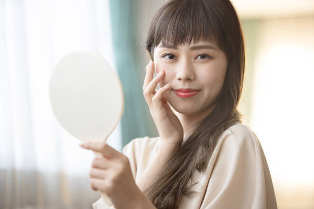 istock Woman looking in the mirror 1289508386