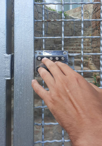 istock A person dials a code on a digital lock. Breaking the combination lock. Metal door with a combination lock. 1289511507