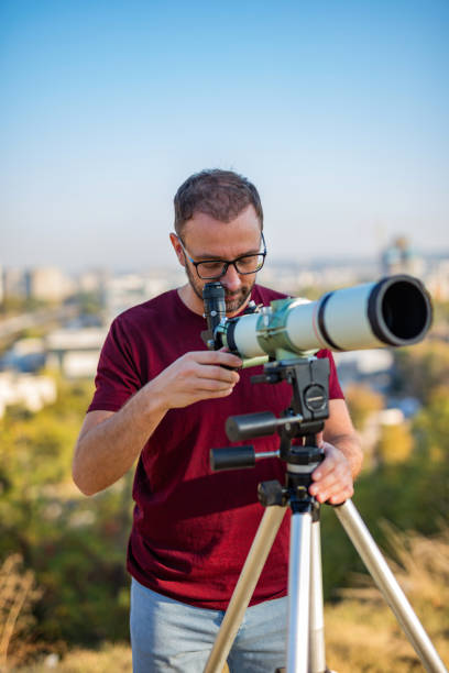 istock Amateur astronomer looking at the sky with a telescope. 1289511741