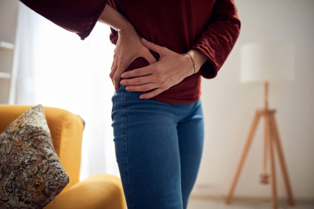 istock Woman with strong hip pain at home. 1289512802