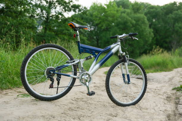 istock beautiful mountain bicycle is on sand road on green nature background 1289515030