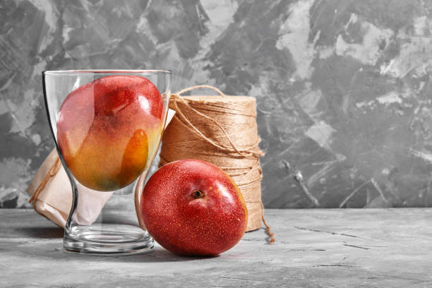 istock Fresh sweet mangoes on concrete background, side view. Flat lay. Copy space 1289515570
