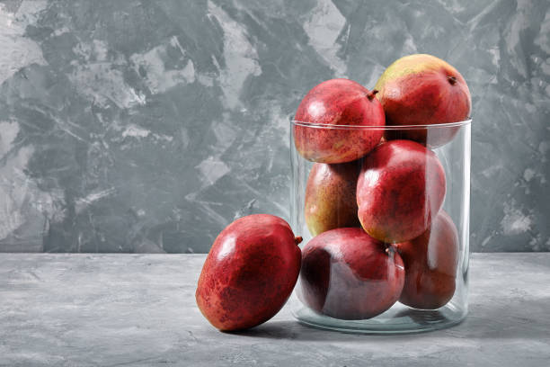 istock Fresh sweet mangoes on concrete background, side view. Flat lay. Copy space 1289515614