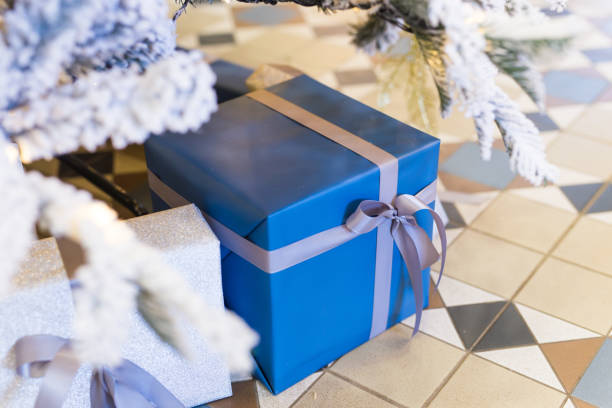 istock Wrapped gifts under a Christmas tree. Winter holidays concept. 1289523680
