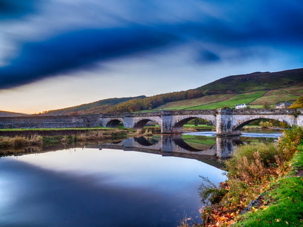 istock Long exposure showing cloud movement over old stone bridge, Burnsall, Wharfedale, Yorkshire Dales, North Yorkshire, England, Britain 1289524121