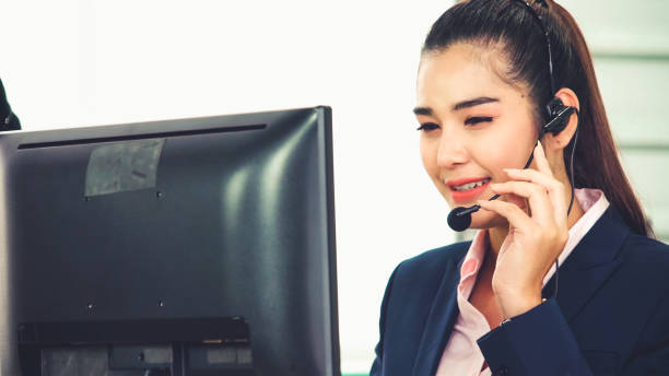 istock Business people wearing headset working in office 1289526114