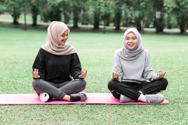 istock Beautiful muslim ladies doing exercise at a public park during a sunny day 1289526248