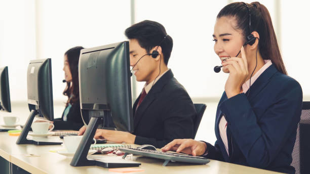 istock Business people wearing headset working in office 1289526320