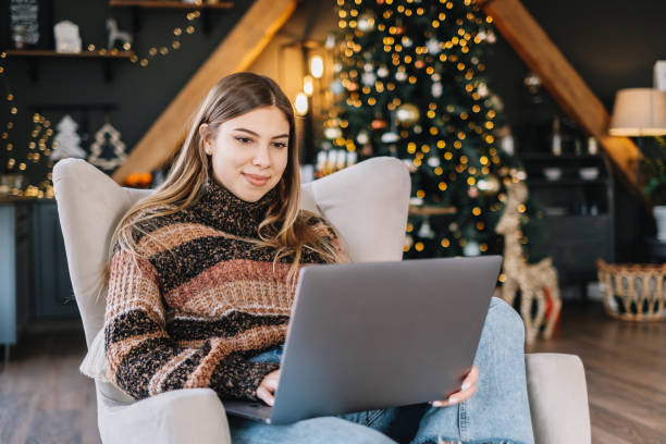 istock Young caucasian woman using laptop computer in holidays at home. 1289529368