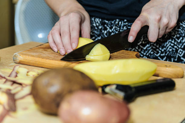 istock A Woman is Peeling of Potatoes and Preparing a Dinner. 1289531926