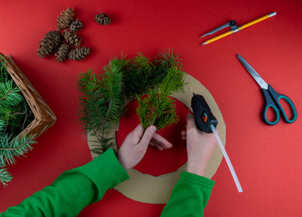 istock Step 3. Step by step instructions. How to make a Christmas wreath from coniferous fir branches, cardboard, and a glue gun. New Year's decor. Creative crafts. Do it yourself. DIY master class 1289532772