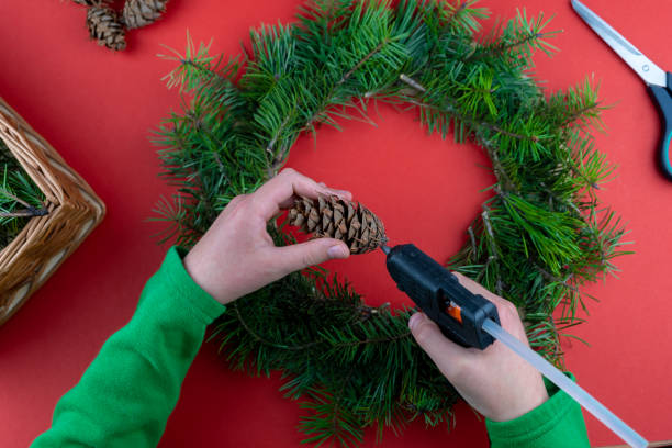 istock Step 5. Step by step instructions. How to make a Christmas wreath from coniferous fir branches, cardboard, and a glue gun. New Year's decor. Creative crafts. Do it yourself. DIY master class 1289532815