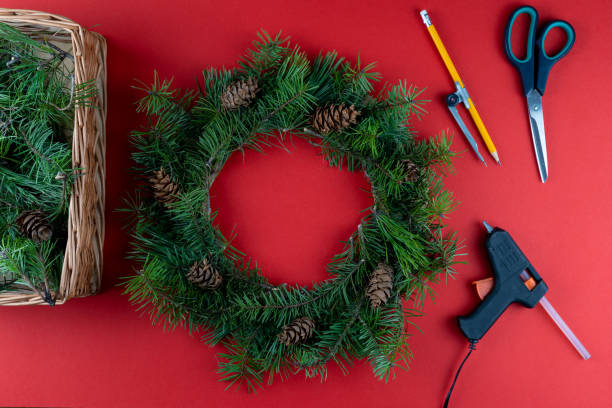 istock Step 7. Step by step instructions. How to make a Christmas wreath from coniferous fir branches, cardboard, and a glue gun. New Year's decor. Creative crafts. Do it yourself. DIY master class 1289532861