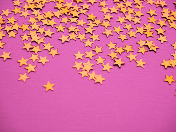 istock Golden stars glitter on pink background 1289534158