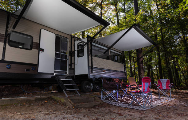 istock Travel trailer with camp set up and waiting chairs 1289534957