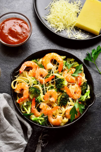 istock Shrimp and broccoli pasta on plate 1289535847