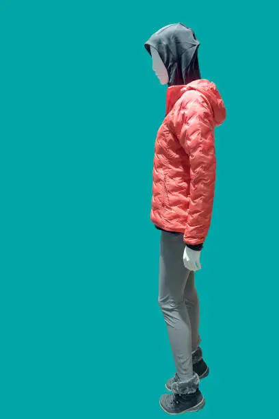 Full length female mannequin dressed in a red lightweight quilted jacket, isolated. No brand names or copyright objects.