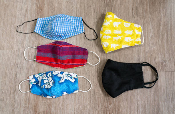 istock Colorful cloth face masks on wooden background 1289536818