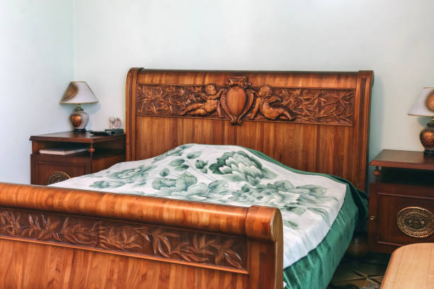 istock Wood bed with carved headboard 1289537539