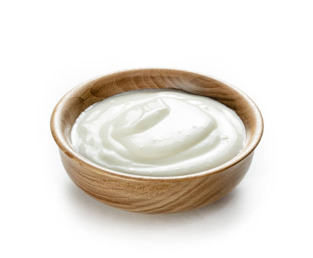 istock cream sour in small wooden bowl  isolated white background 1289537886