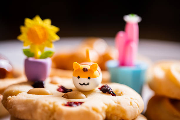 two gingerbread cookies, in the shape of emoticons, emotions and cute faces, concept, on a yellow background