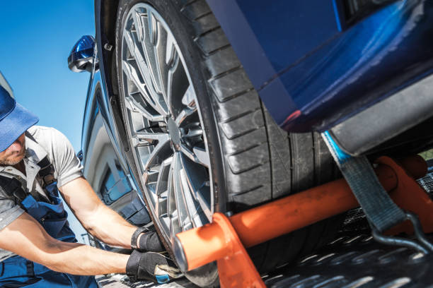 istock Towing Truck Driver Securing Vehicle Cargo 1289544557