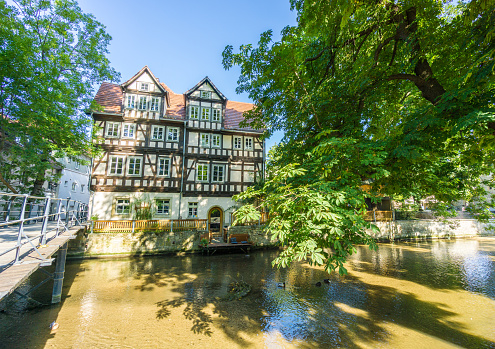 Zurich, Switzerland-May 27, 2023; Historic houses along the Limmat river on the Limmatquai from the Munsterbrucke (bridge) over the Limmat river in Altstadt Zurich against a blue sky