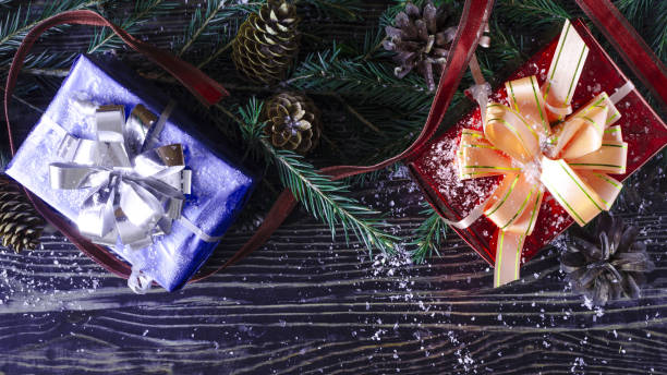 istock Red and blue gift box, decorations and fir branches on a dark background Christmas and new year theme. The view from the top 1289547865