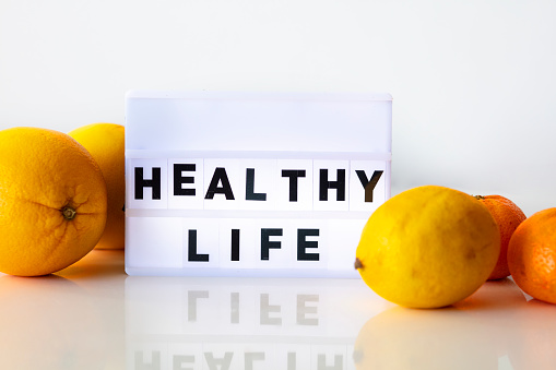 HEALTHY LIFE concepts with text on light box on desk table in home office.positive emotion to success