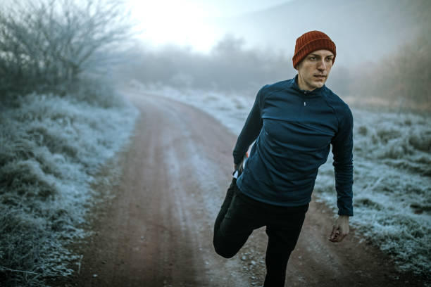 istock Runner stretching leg and feet and preparing for running outdoors 1289549713