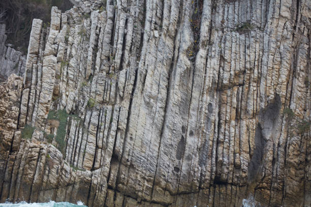 Rock formation and waves at beach.Rugged and rocky coastal scenic with rough surf.