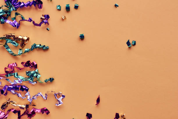 istock Party colorful confetti over pastel paper background. Sparkles, glitter, tinsel elements new year celebration frame. Flat lay, top view, copy space banner 1289553784