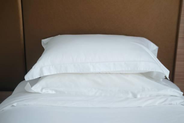 istock White pillow on white bed decoration in bedroom interior 1289556649