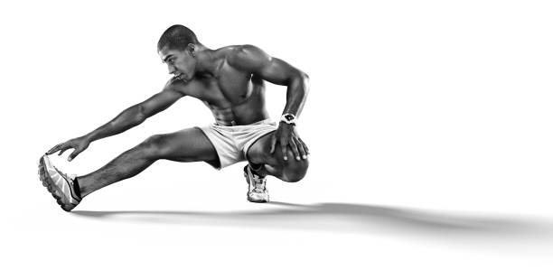 Sport. Sprinter doing stretching exercises and smiling on the floor. Isolated on white.