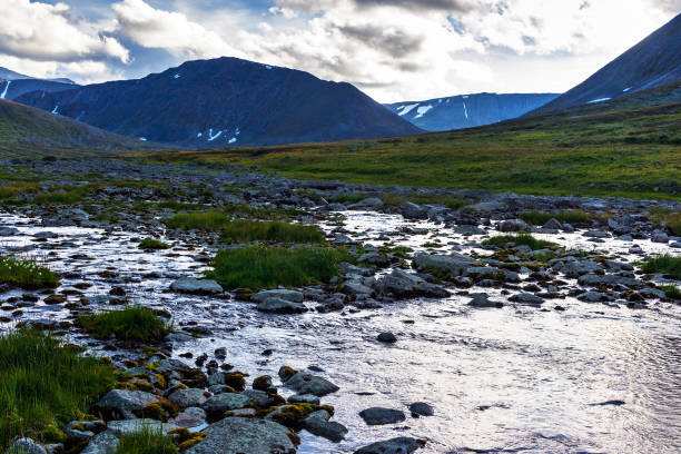 istock Stream and mountain peak in the Subpolar Urals on a summer evening 1289557743