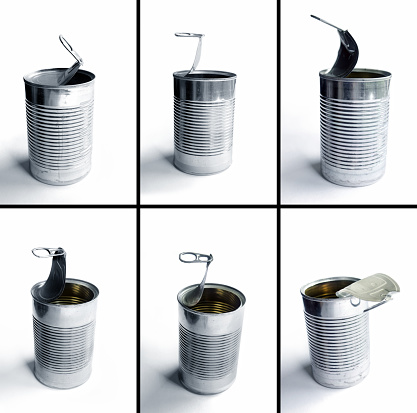 Close up design element of opened shiny metal can containers in a row over white background