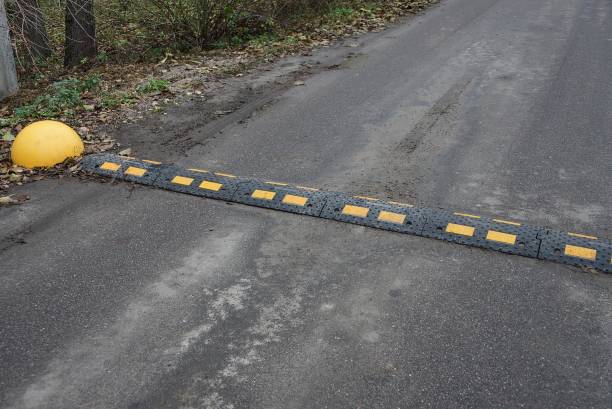 istock long dirty black yellow speed bump 1289561832