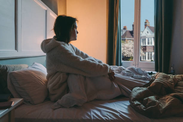 istock Sick woman with COVID-19 in bed 1289564146