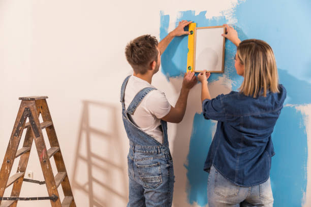 istock Using a level to see if the picture frame is even on the wall 1289565201