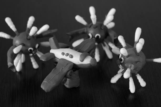 The figures of the virus on the table. Near a toy plane.