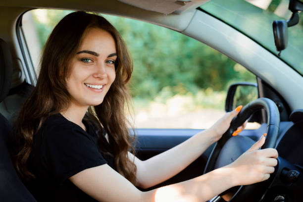 istock Cheerful female just after receiving car licence. 1289568070