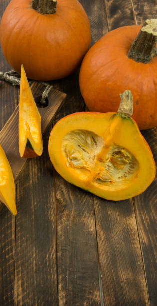istock autumn background with pumpkin on wooden board 1289568537